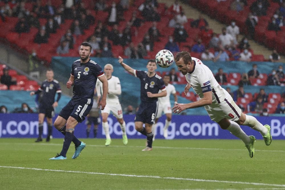 England's Harry Kane heads the ball during the Euro 2020 soccer championship group D match between England and Scotland at Wembley stadium in London, Friday, June 18, 2021. (Carl Recine /Pool Photo via AP)